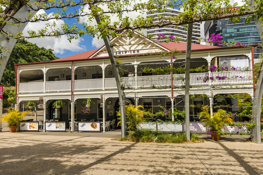 Photograph of a building with trees in front