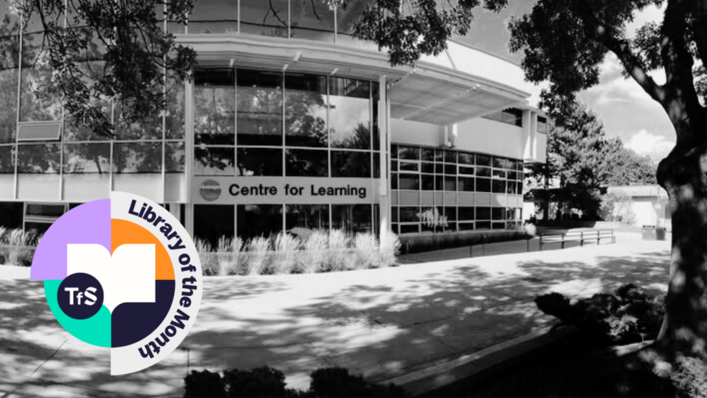 Black and white photo of inside of a library with Library of the Month logo